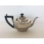 A small batchelors' half fluted silver teapot of typical