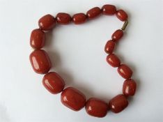 A large graduated string of beads with barrel clas