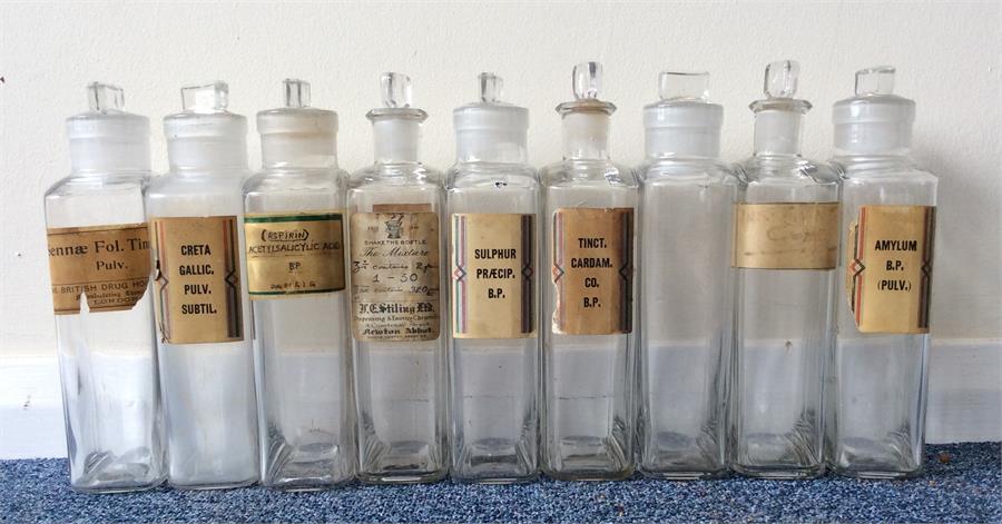 A set of nine old chemist bottles with lift-off gl