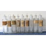 A set of nine old chemist bottles with lift-off gl