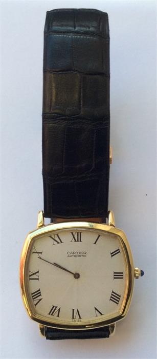 A slim 18 carat Cartier wristwatch with silvered d