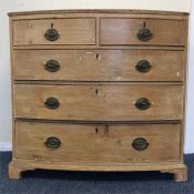 A Georgian pine five drawer bow front chest on bra