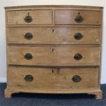 A Georgian pine five drawer bow front chest on bra