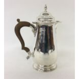 A good quality Georgian style silver water jug with hinge