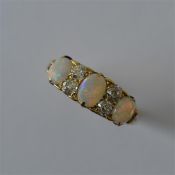 An opal and diamond seven stone half hoop ring in