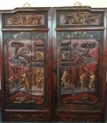 A pair of large Chinese carved wooden panels with