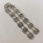 A Chinese silver thirteen panel belt with chain link susp