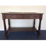 An Edwardian carved top two drawer side table. Est