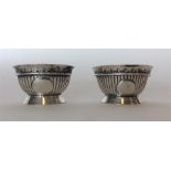 A pair of Victorian silver fluted salts with gilt interio