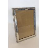A good quality large silver picture frame with fancy bead