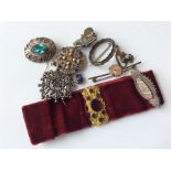 A bag containing silver and other brooches, earrin