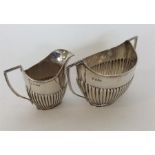 A silver half fluted cream and sugar basin. Sheffi