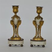A pair of good quality candlesticks with ram's hea