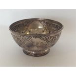 A small Victorian silver sugar bowl decorated with