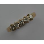 A small diamond five stone ring in gold claw mount