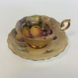 A Royal Worcester cabinet cup and saucer decorated