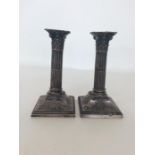 A good pair of silver Corinthian column candlesticks on s