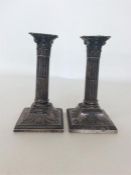 A good pair of silver Corinthian column candlesticks on s