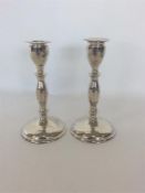 A tall pair of silver tapering candlesticks on circular b