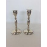 A tall pair of silver tapering candlesticks on circular b