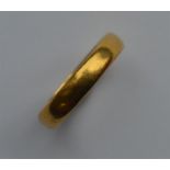 A small plain 22 carat gold wedding band. Approx.