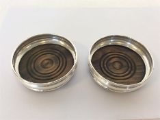 A pair of modern small silver mounted coasters wit