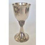 A tall Continental silver goblet of hammered form. Approx