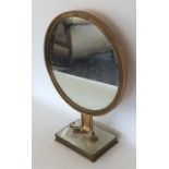 A stylish mirror on brass mounted base. Est. £30 -