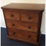 A small mahogany chest of four drawers on bun feet