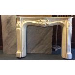 A large white fire surround with marble top and ba