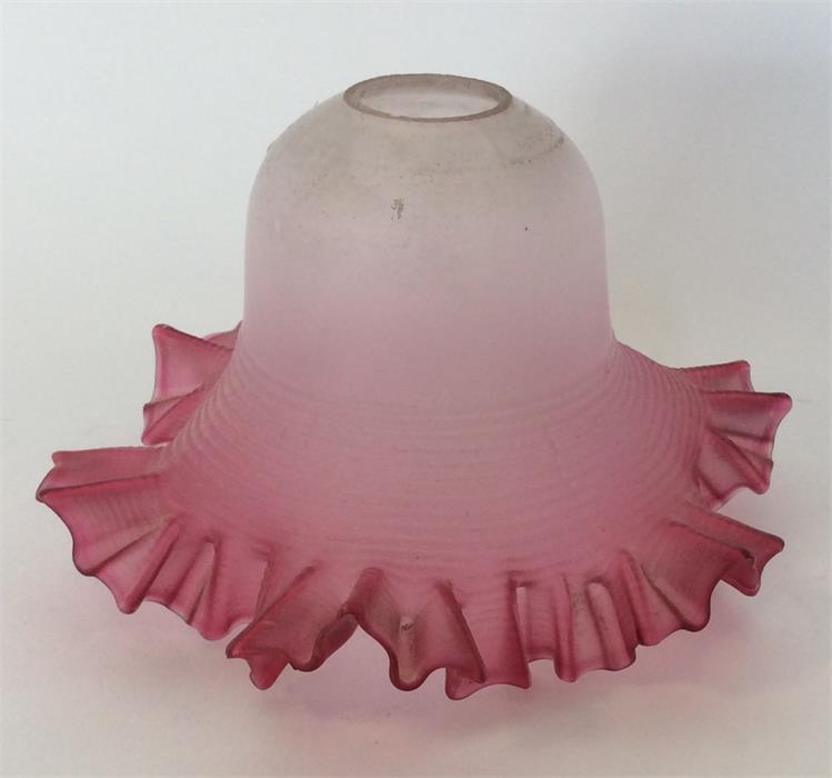 A cranberry glass lampshade with wavy edge. Est. £