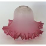 A cranberry glass lampshade with wavy edge. Est. £