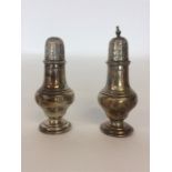 A pair of Edwardian silver peppers of baluster form. Ches
