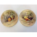 A pair of Royal Worcester tea plates decorated wit