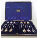 A large boxed set of twelve silver teaspoons with matching