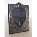 A large silver heart shaped frame embossed with fl