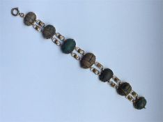 A good early gold bracelet mounted with scarabs an