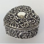 An attractive silver embossed heart shaped box wit