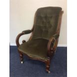 A mahogany button back armchair with scroll arms a