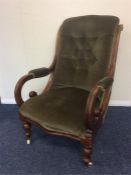 A mahogany button back armchair with scroll arms a