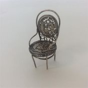 A filigree silver mounted miniature chair with lea