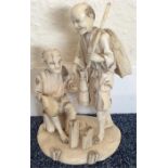 A good carved Antique ivory figure of two men on r
