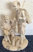 A good carved Antique ivory figure of two men on r