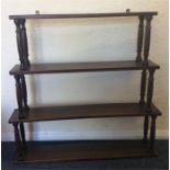 A mahogany shelf with turned supports. Est. £20 -