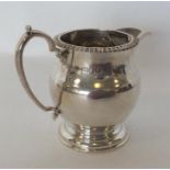 A good Edwardian silver cream jug with gadroon rim