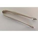 A pair of bright cut silver sugar tongs of typical design