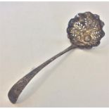 A silver embossed sifter ladle attractively decora