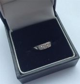 A small diamond three stone ring in 18 carat white