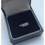 A small diamond three stone ring in 18 carat white