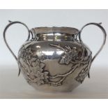 A Chinese silver sugar bowl with textured body mounted wi